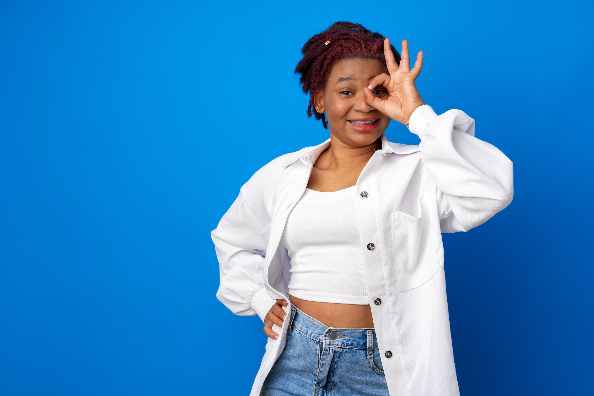 Smiling woman making an OK sign